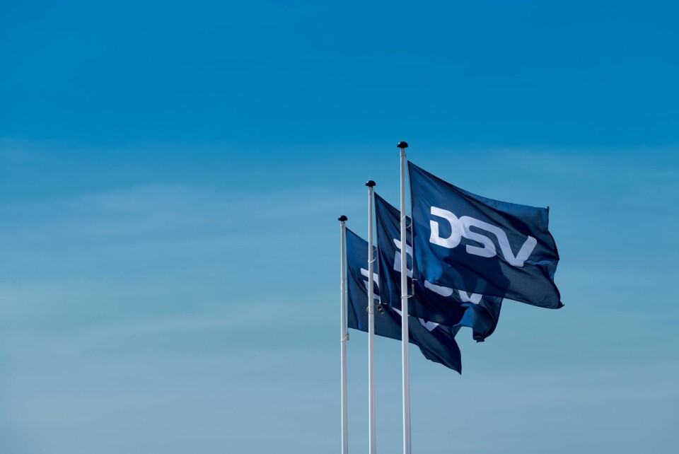 DSV’s acquisition of DB Schenker marks a major expansion in its global logistics network, setting the stage for increased market reach and enhanced capabilities Green and blue DSV flags waving in the wind against a clear sky backdrop
